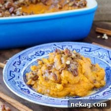 A serving of lightened up sweet potato casserole, showcasing its smooth texture and golden crumble.
