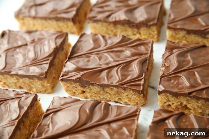 A close-up shot of a single Scotcharoo bar, showing the vibrant chocolate and butterscotch topping with a hint of the peanut butter base.