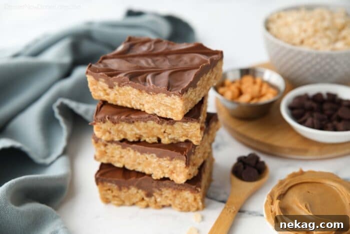 A stack of three Scotcharoos, beautifully presented, highlighting the distinct layers of chocolate butterscotch topping and peanut butter rice krispie base.