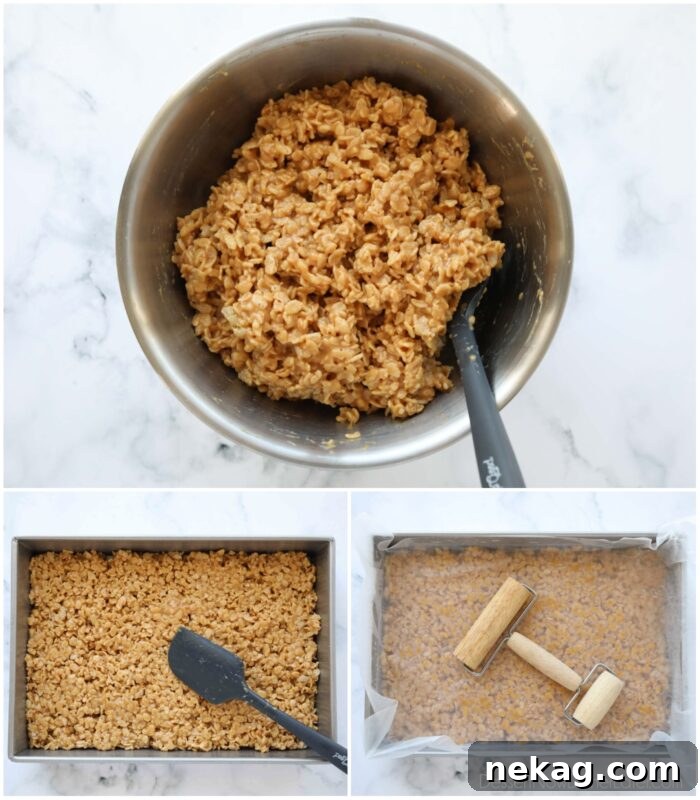 Crispy rice cereal coated with a delicious peanut butter syrup being transferred to a pan and gently flattened with a spatula and mini rolling pin to create an even layer.