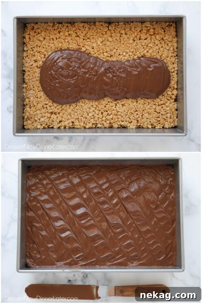 Melted chocolate and butterscotch topping being poured over the peanut butter rice krispie treats and then expertly spread smooth with an offset spatula for an even coating.
