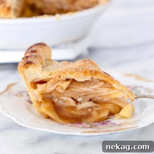 A round image of a Cinnamon Apple Pie slice on a plate with floral details.