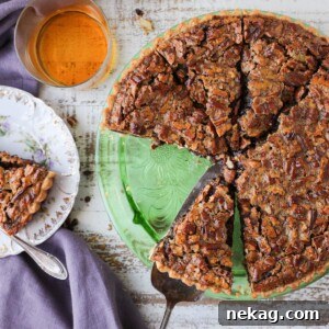 A round image of a Bourbon Chocolate Pecan Tart on a tablescape.