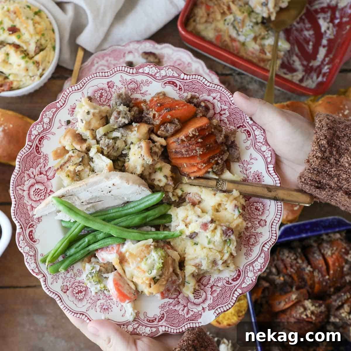 Thanksgiving dinner plate piled high with a selection of easy Thanksgiving dishes, held by a hand.