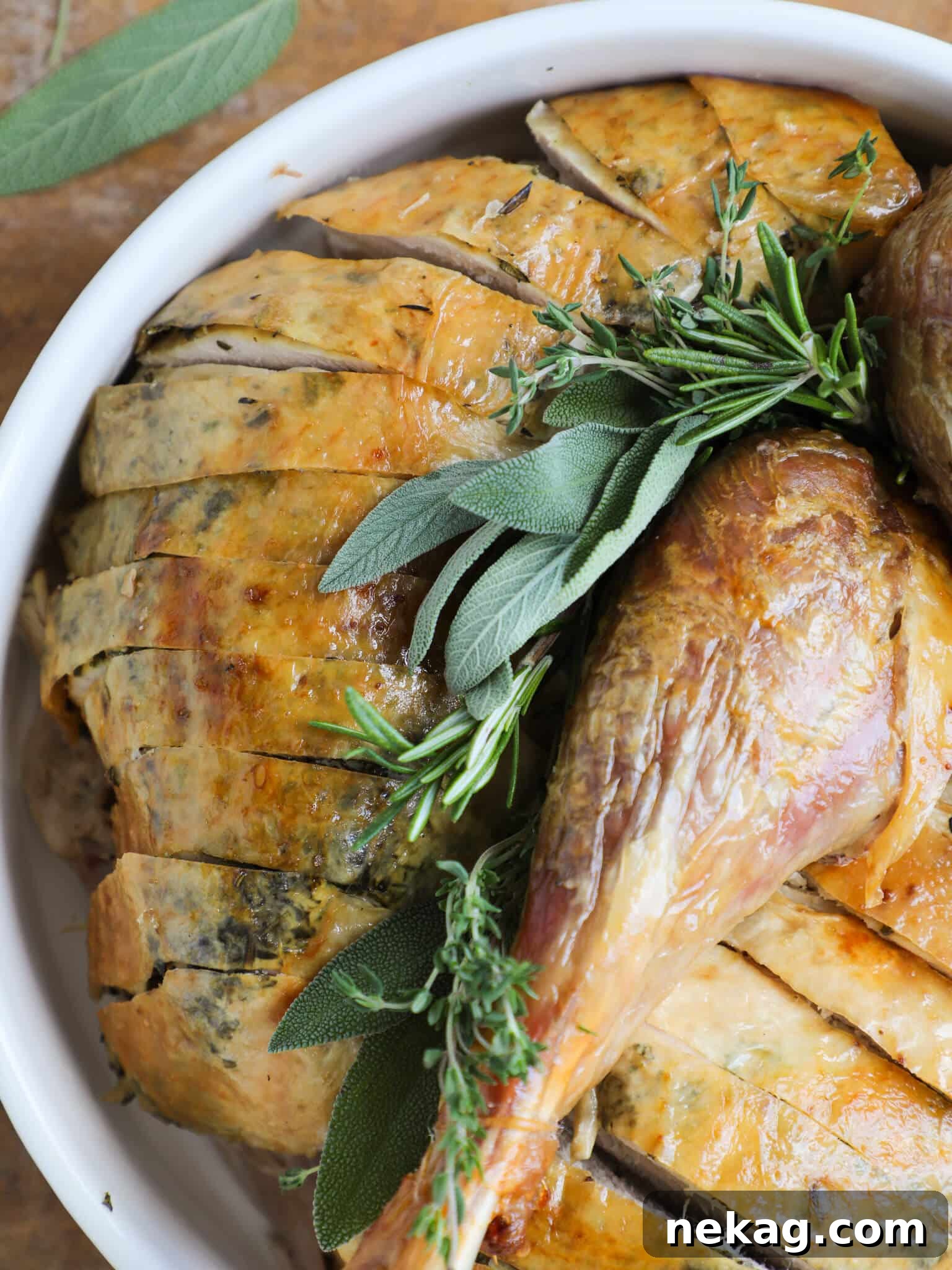 A beautifully roasted herb-infused turkey presented on a pristine white plate, garnished for the holiday.