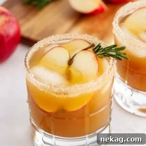 A harvest apple ginger smash with rosemary garnish.