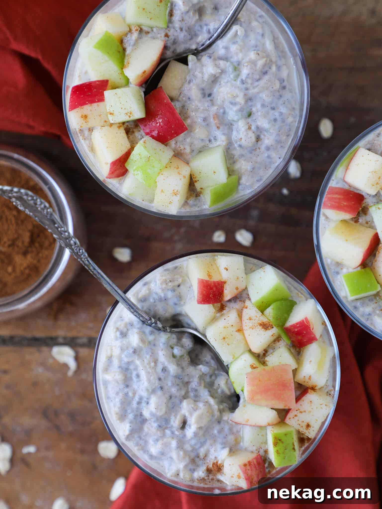 Spiced Apple Pie Overnight Oats 2 Fresh apples, cinnamon sticks, and a jar of Apple Pie Overnight Oats