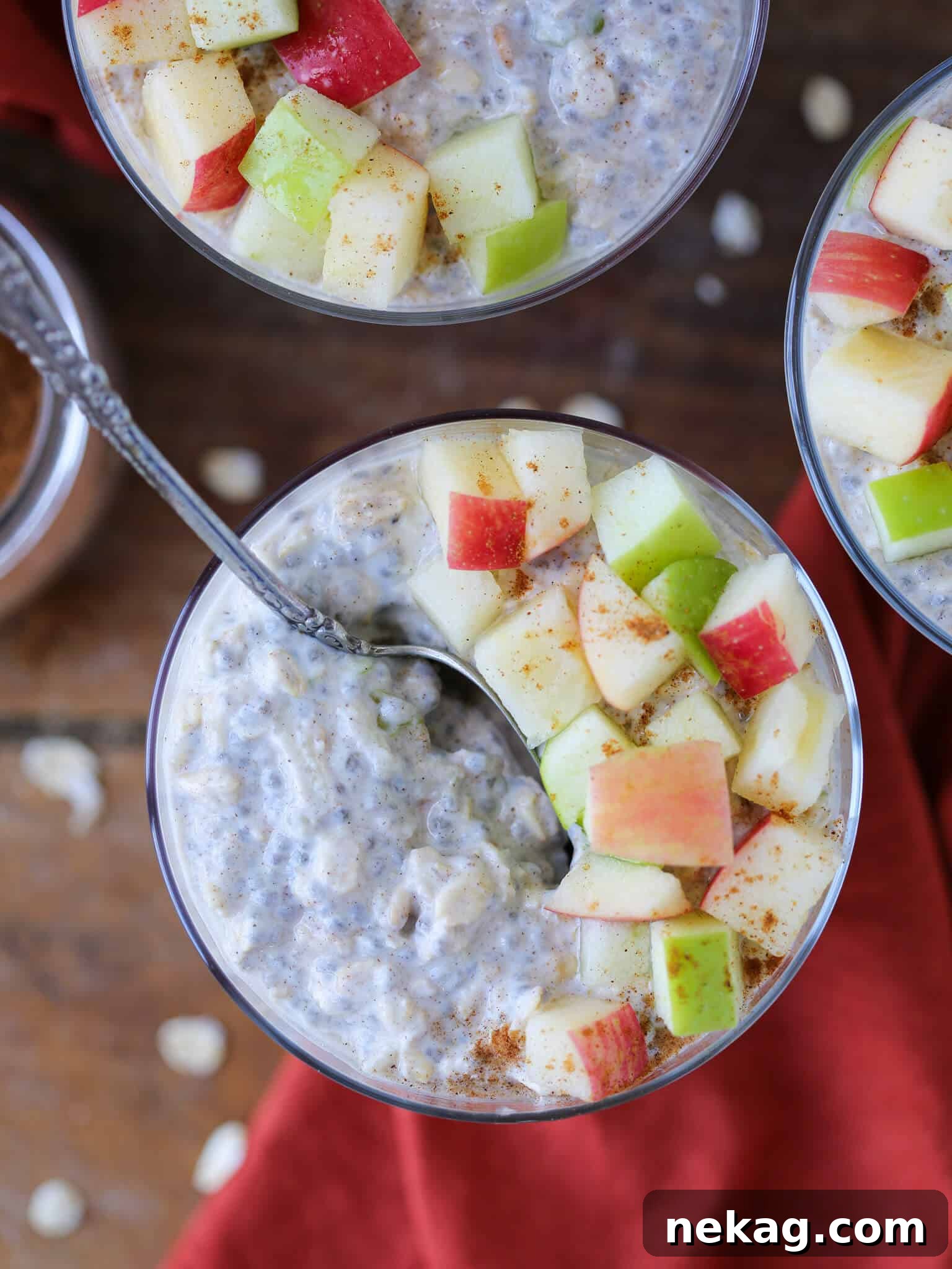 Spiced Apple Pie Overnight Oats 4 Apple Pie Overnight Oats served in a glass jar with a silver spoon