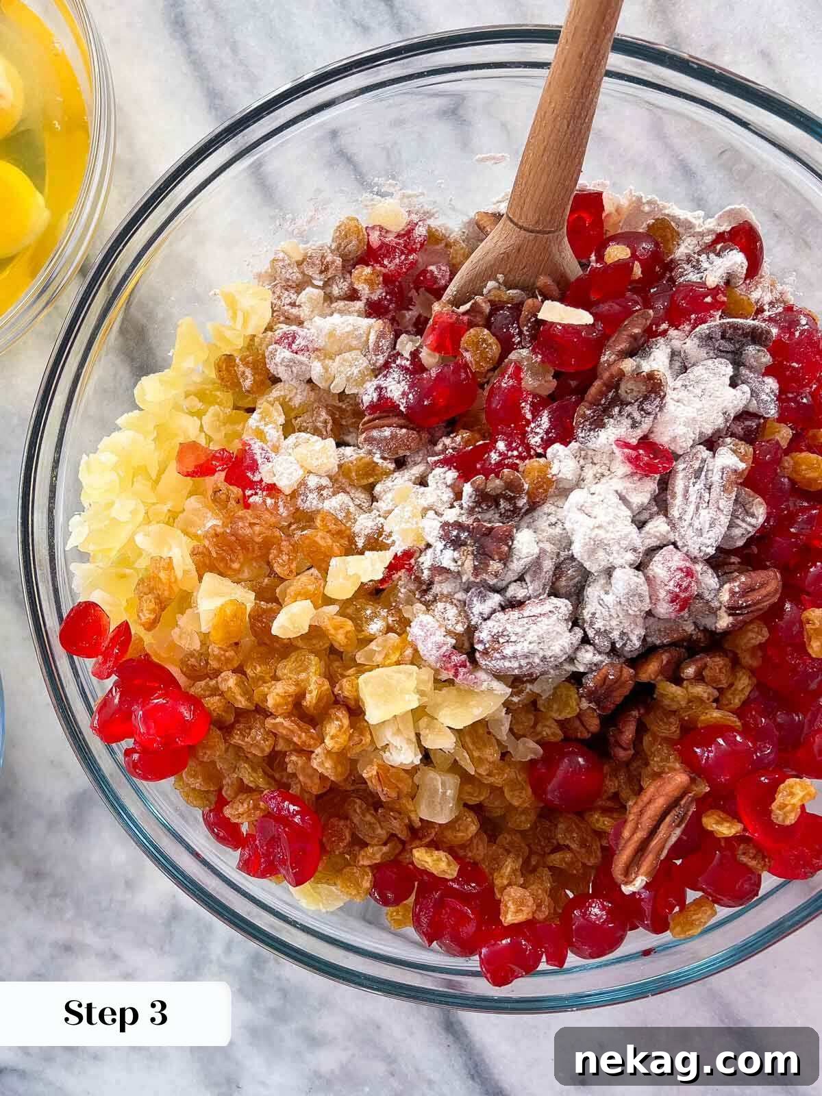 Chopped dried fruit and nuts mixed in a bowl, ready for the fruit cake batter.