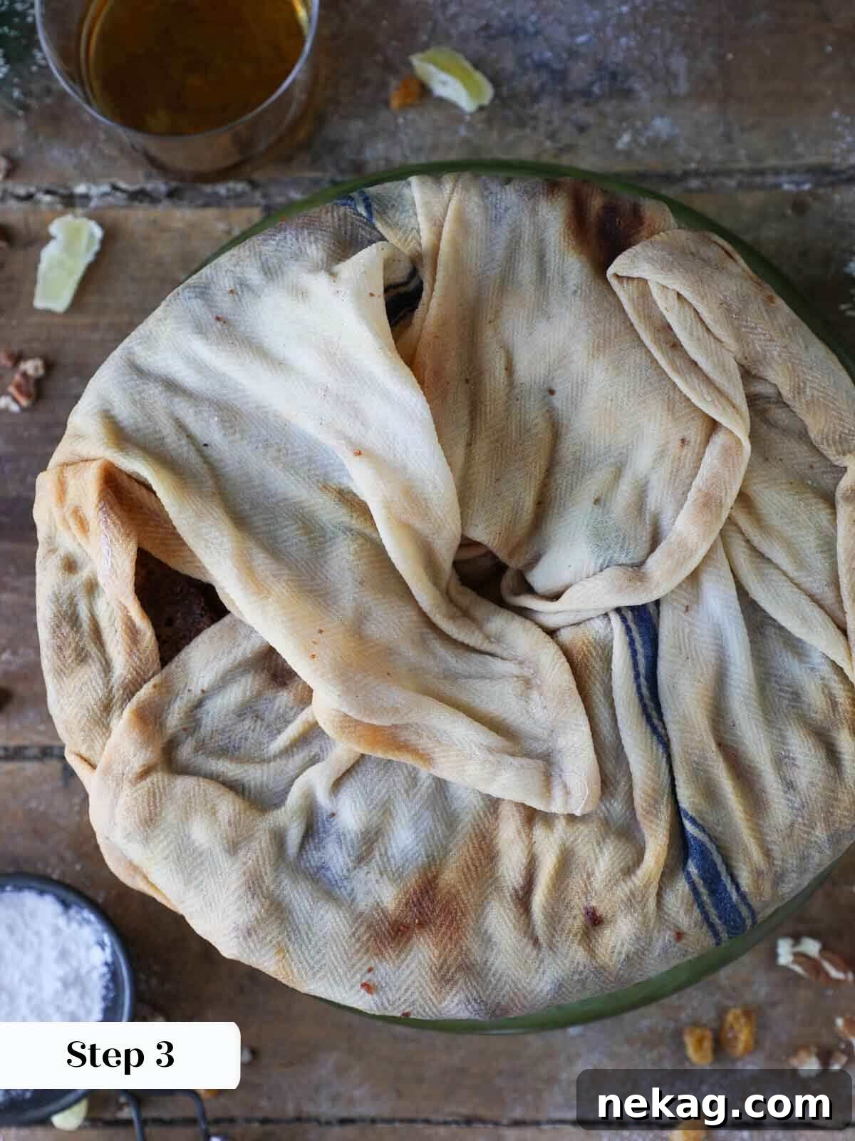 Fruit cake meticulously wrapped in a spirit-soaked towel, ready for the aging process.