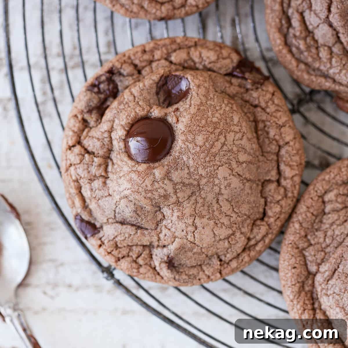 Nutella Chocolate Chip Cookies cooling on a circular wire rack.