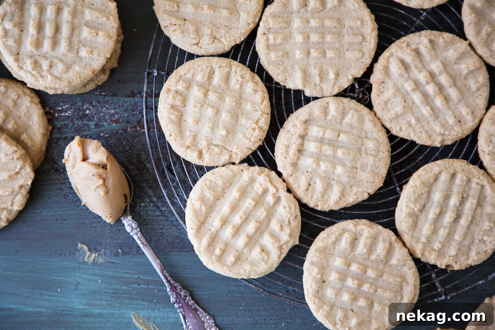 A group of golden-brown old fashioned peanut butter cookies cooling on a vintage wire rack, a delightful sight for any baker.