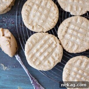 Old Fashioned Peanut Butter Cookies on cooling rack with perfect fork tine impressions, a classic sight.