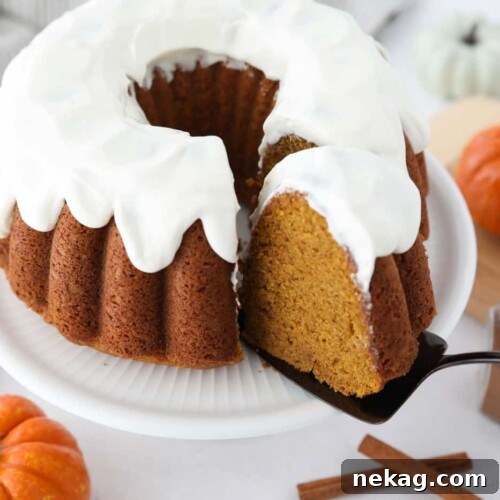 Spiced Pumpkin Crown 11 Top view of a slice of pumpkin bundt cake being removed with a cake server.