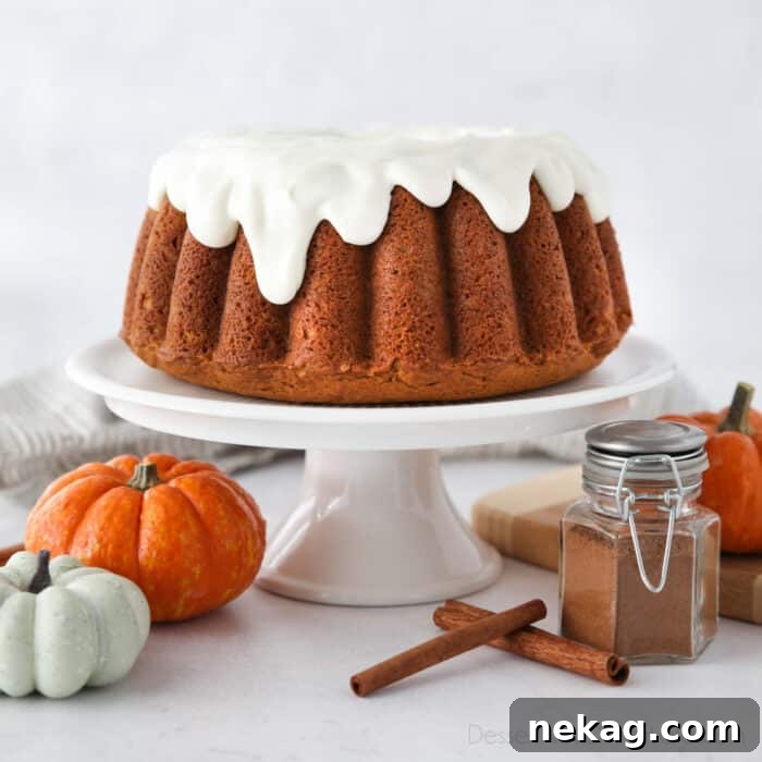 Spiced Pumpkin Crown 8 Cake stand with pumpkin bundt cake topped with cream cheese frosting.
