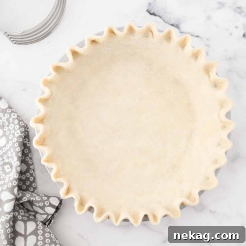 All butter pie crust fitted in pan with crimped edges.