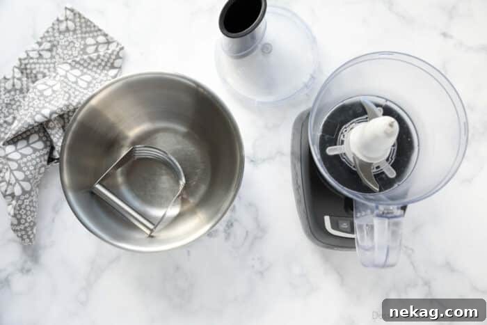 Flaky Butter Pie Crust 5 A side-by-side comparison of pie crust tools: a bowl with a pastry blender and a food processor, highlighting the two main preparation methods.