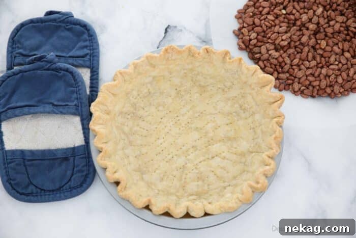 Perfecting Your Blind Baked Pie Crust 10 A fully baked and perfectly golden-brown empty pie crust sits in its pan, ready for a delicious unbaked filling.