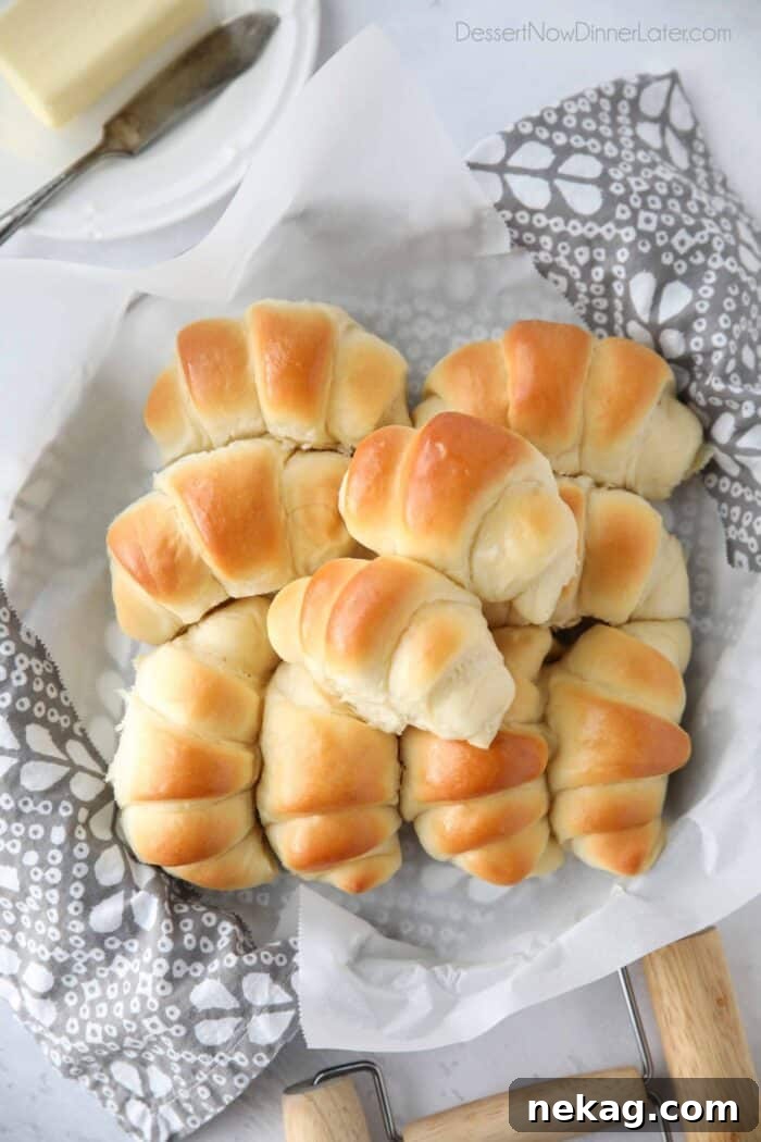 Perfect Homemade Crescent Rolls Video Recipe 2 A basket brimming with golden-brown, fluffy homemade crescent rolls, ready to be enjoyed.