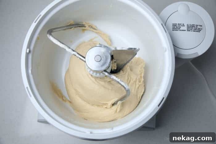 Perfect Homemade Crescent Rolls Video Recipe 8 Yeast dough being expertly kneaded in a stand mixer, demonstrating the dough hook's action.