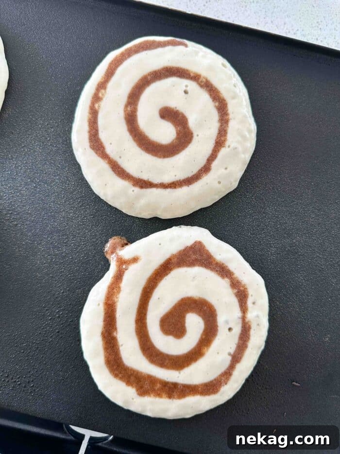 Swirled Cinnamon Pancake Stacks 6 Cooking cinnamon swirl pancakes on a griddle.