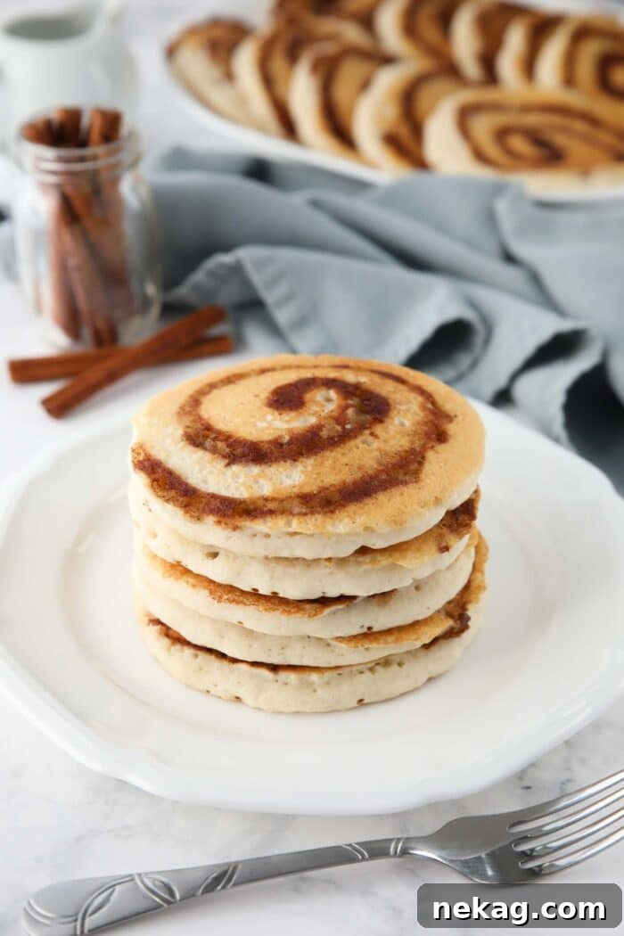 Swirled Cinnamon Pancake Stacks 7 Stack of cinnamon roll pancakes on a plate.