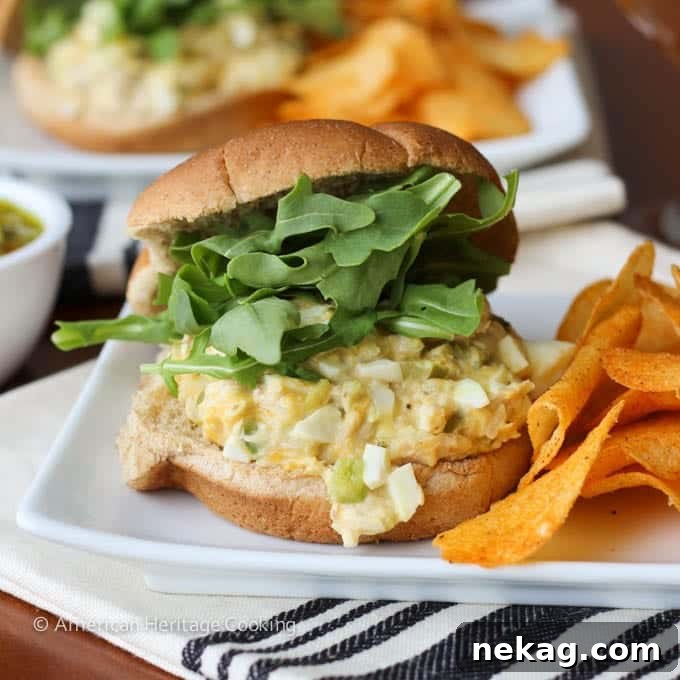 The Ultimate Tuna Melt 4 A beautifully assembled tuna melt sandwich, served on a rustic wooden board with a cloth napkin, ready for a delicious meal.