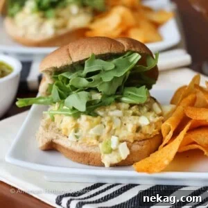 A tuna melt sandwich with a cloth napkin.
