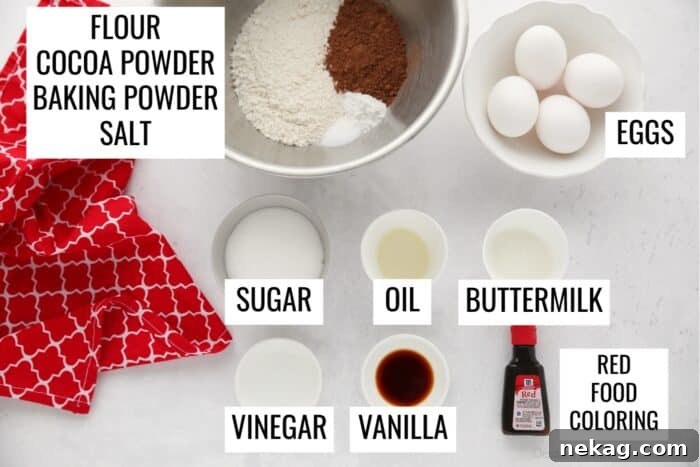 Mastering the Red Velvet Cake Roll 7 A selection of Red Velvet Cake ingredients including flour, cocoa powder, baking powder, salt, eggs, sugar, oil, buttermilk, vinegar, vanilla extract, and red food coloring.