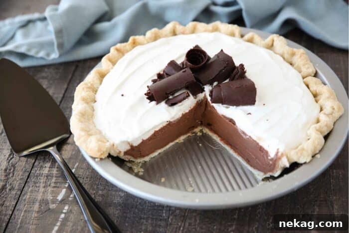 Decadent Chocolate Cream Pie 11 Top-down view of a pie dish holding a finished Chocolate Cream Pie, with two slices already removed, showcasing the remaining perfect pie.