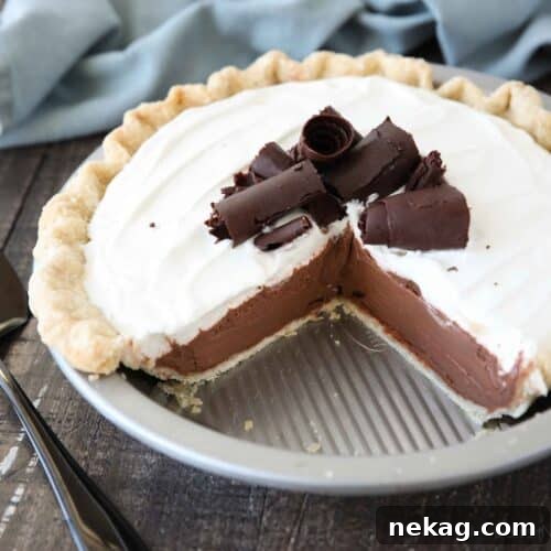 Decadent Chocolate Cream Pie 12 Top view of a pie tin with a couple of pieces taken out of the luscious chocolate cream pie, inviting you to try a slice.