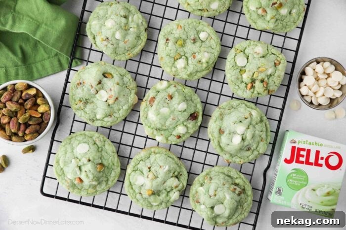 Pudding-Infused Pistachio Delights 8 Top-down view of freshly baked pistachio pudding cookies arranged on a wire cooling rack.