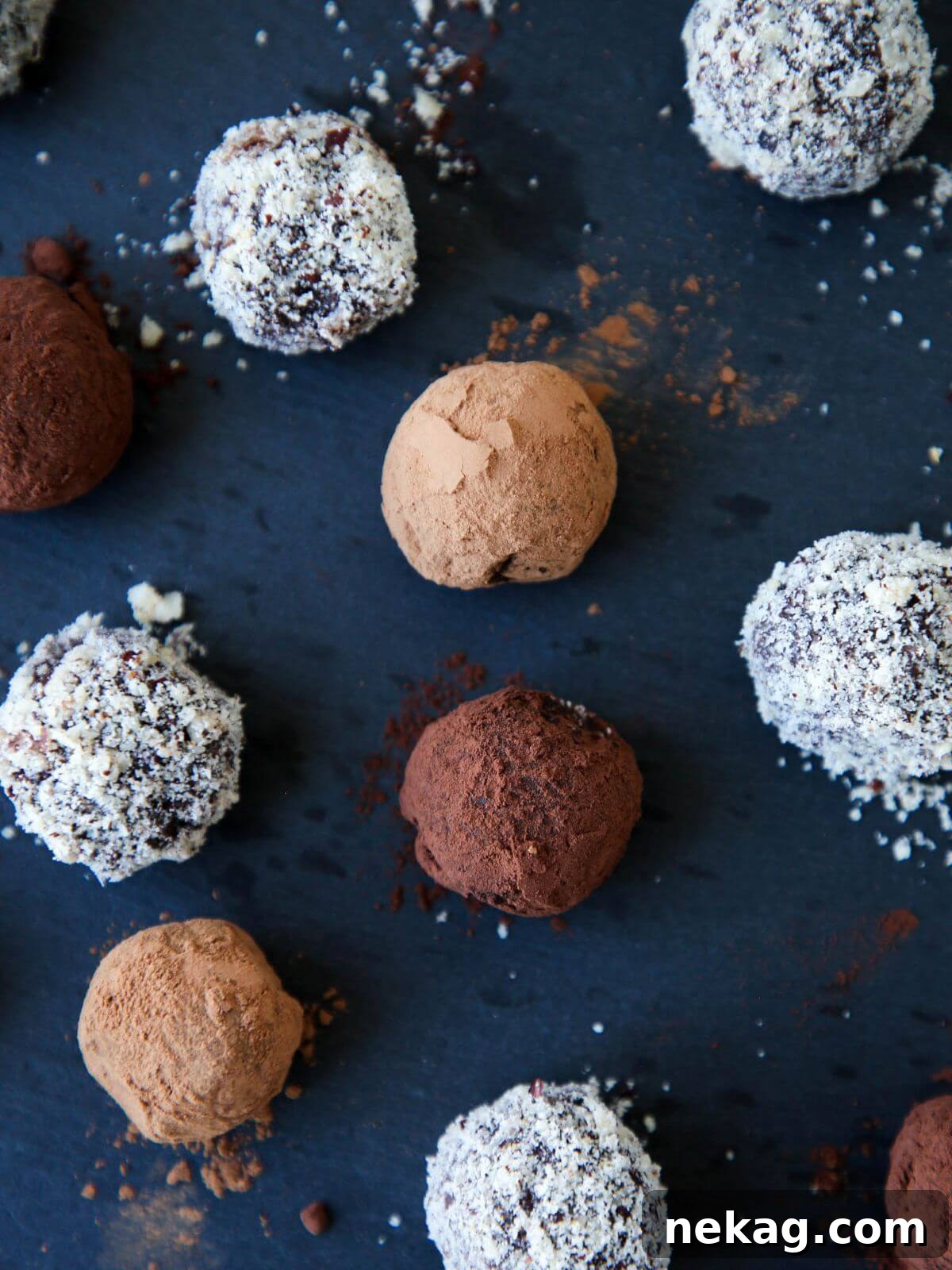Decadent Nutella Truffles 4 Assortment of Nutella truffles coated with different toppings like powdered sugar, cocoa powder, and chopped nuts.