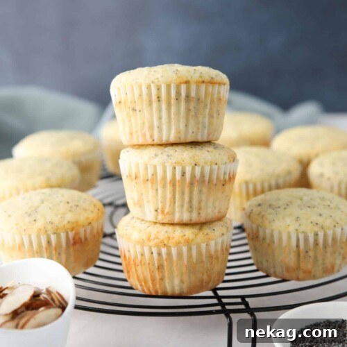 Almond Poppy Seed Muffins stacked on top of each other.
