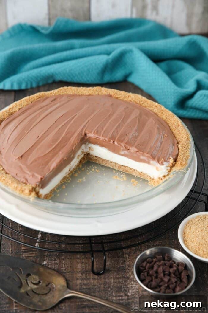 A stunning no-bake chocolate cream cheese pie, with a few slices already removed, revealing its layered perfection and tempting texture.