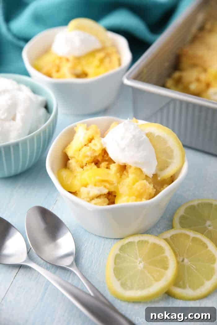 Effortless Lemon Sunshine Cake 4 A close-up view of the baked Lemon Dump Cake, showing the distinct layers of bright lemon pie filling, creamy melted cream cheese, and golden-brown cake mix, all beautifully fused together.