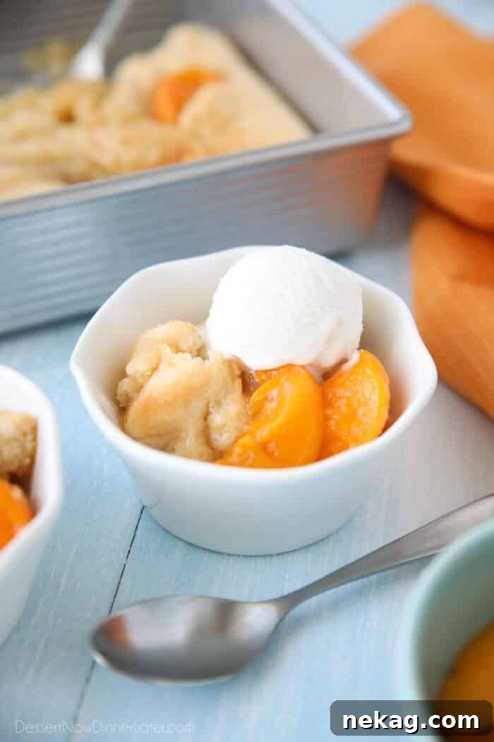 Effortless Peach Cobbler Perfection 4 Peach Cobbler with cake batter crust on top and a scoop of vanilla ice cream.