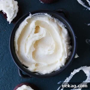 Beautifully swirled cream cheese frosting on a cookie.