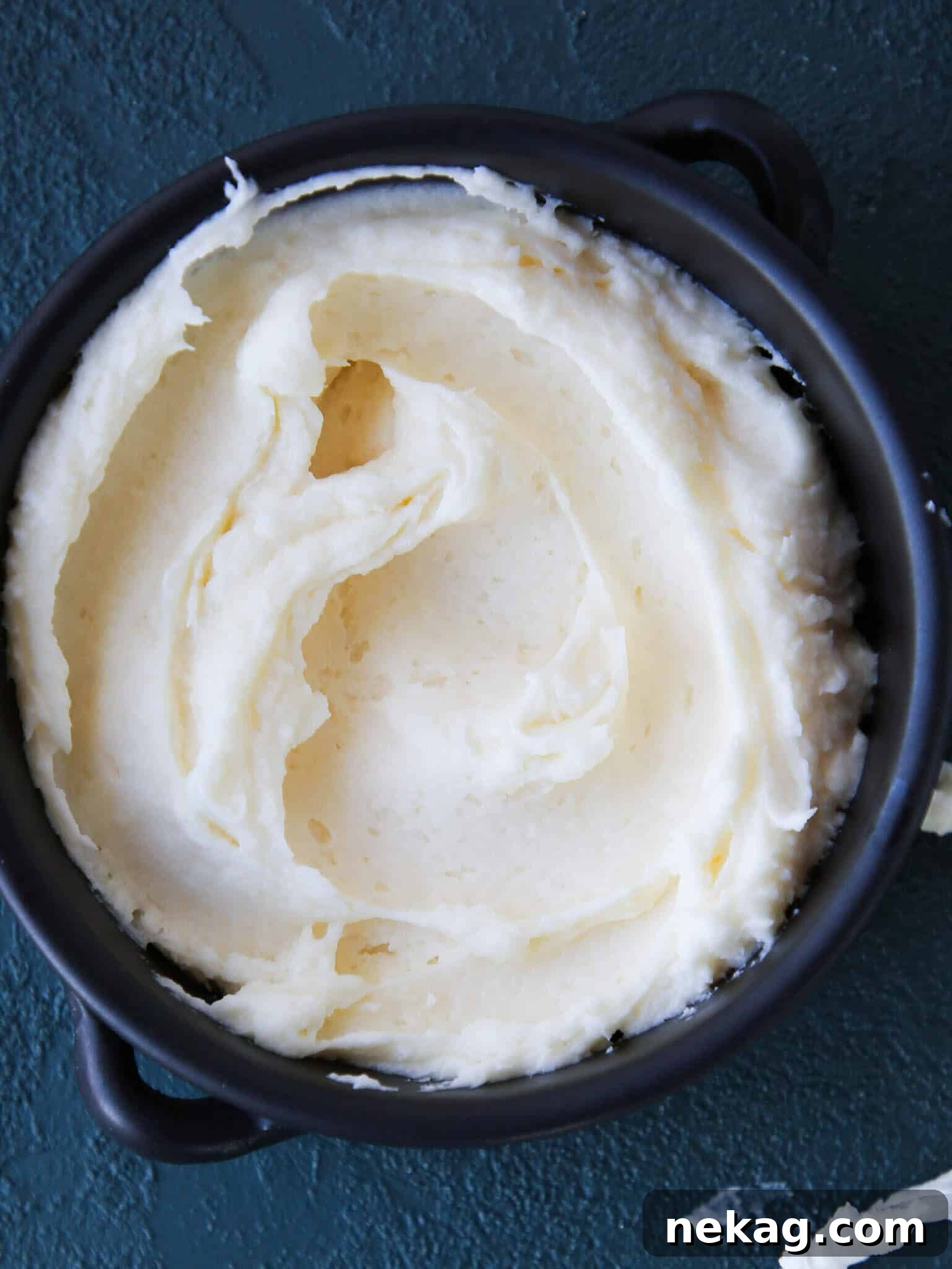 Cream Cheese Frosting in a dark bowl, ready to be used.