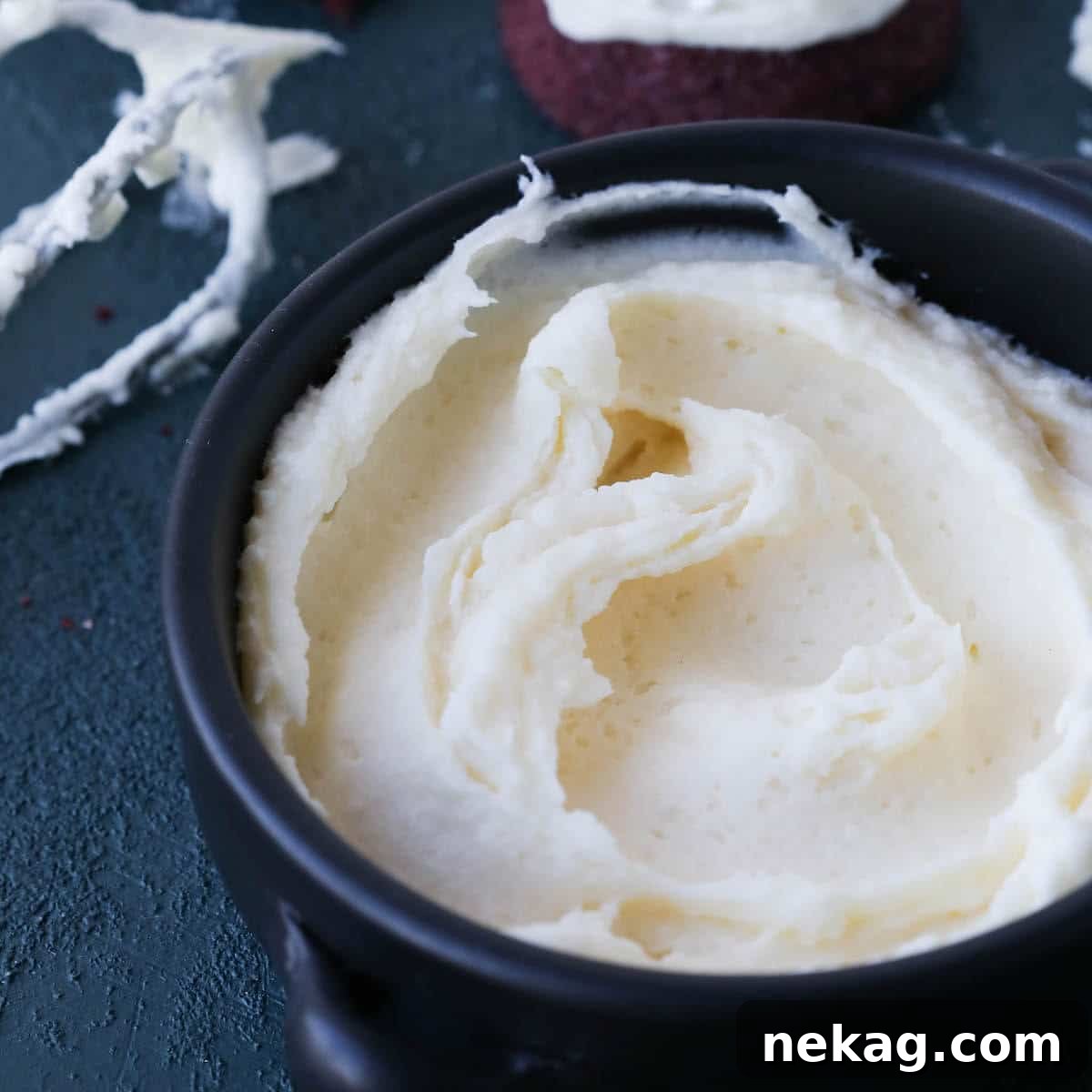Close-up of freshly made cream cheese frosting, showing its smooth texture.