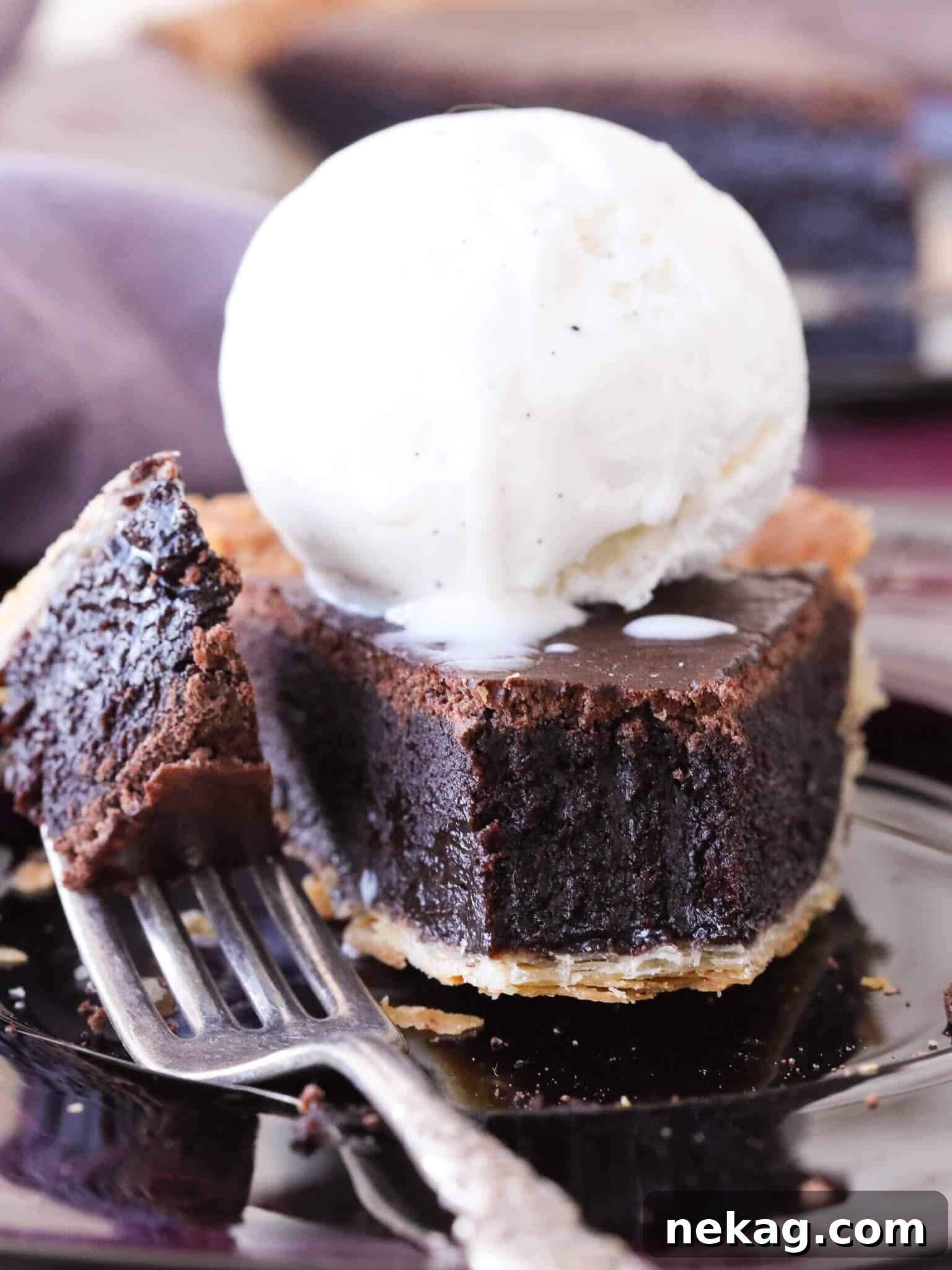 A perfectly sliced piece of easy chocolate fudge pie, showcasing its rich, fudgy interior and flaky crust, ready to be served.