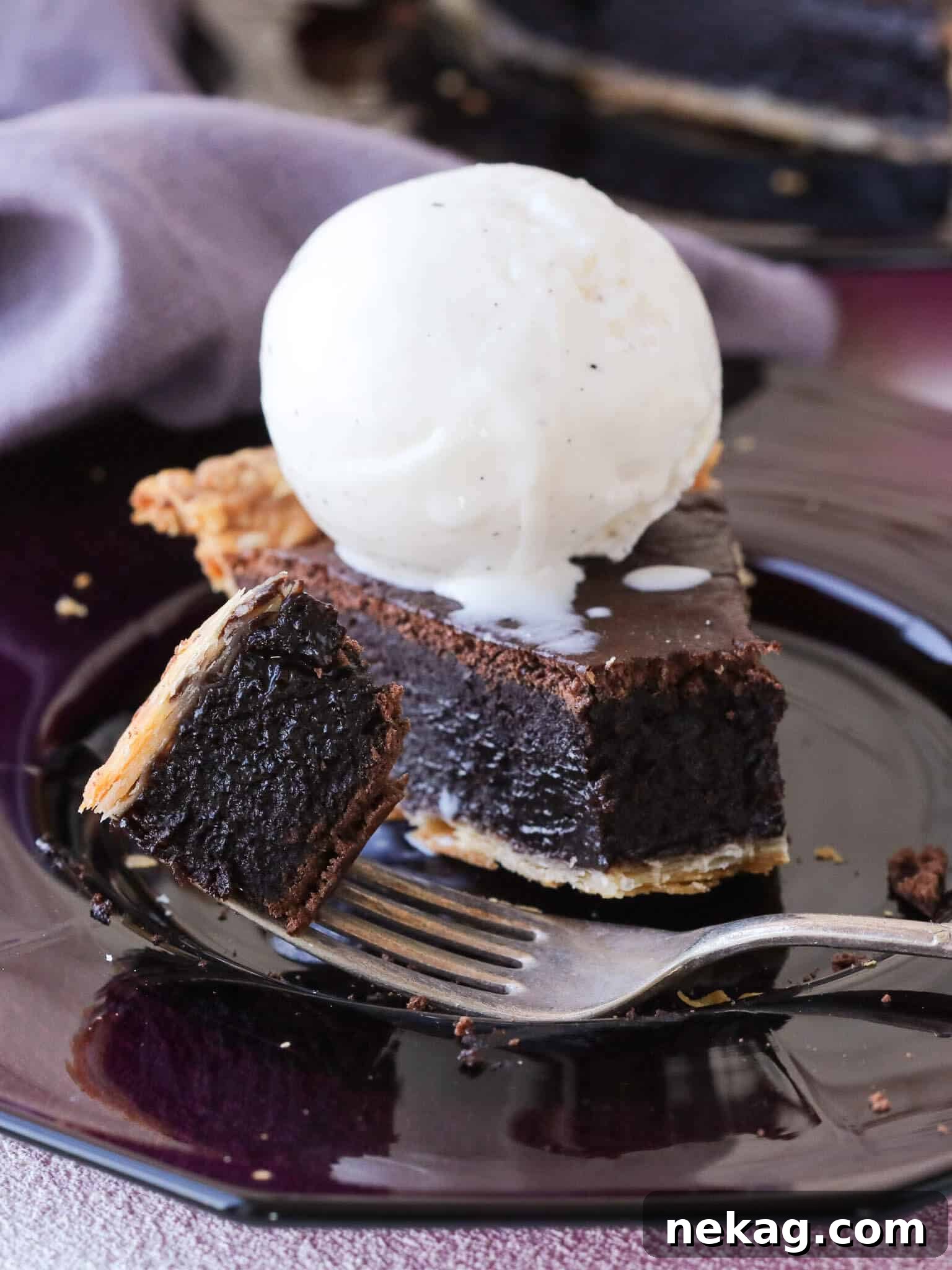 A delectable slice of easy chocolate pie served alongside a scoop of creamy vanilla ice cream, promising a perfect dessert pairing.