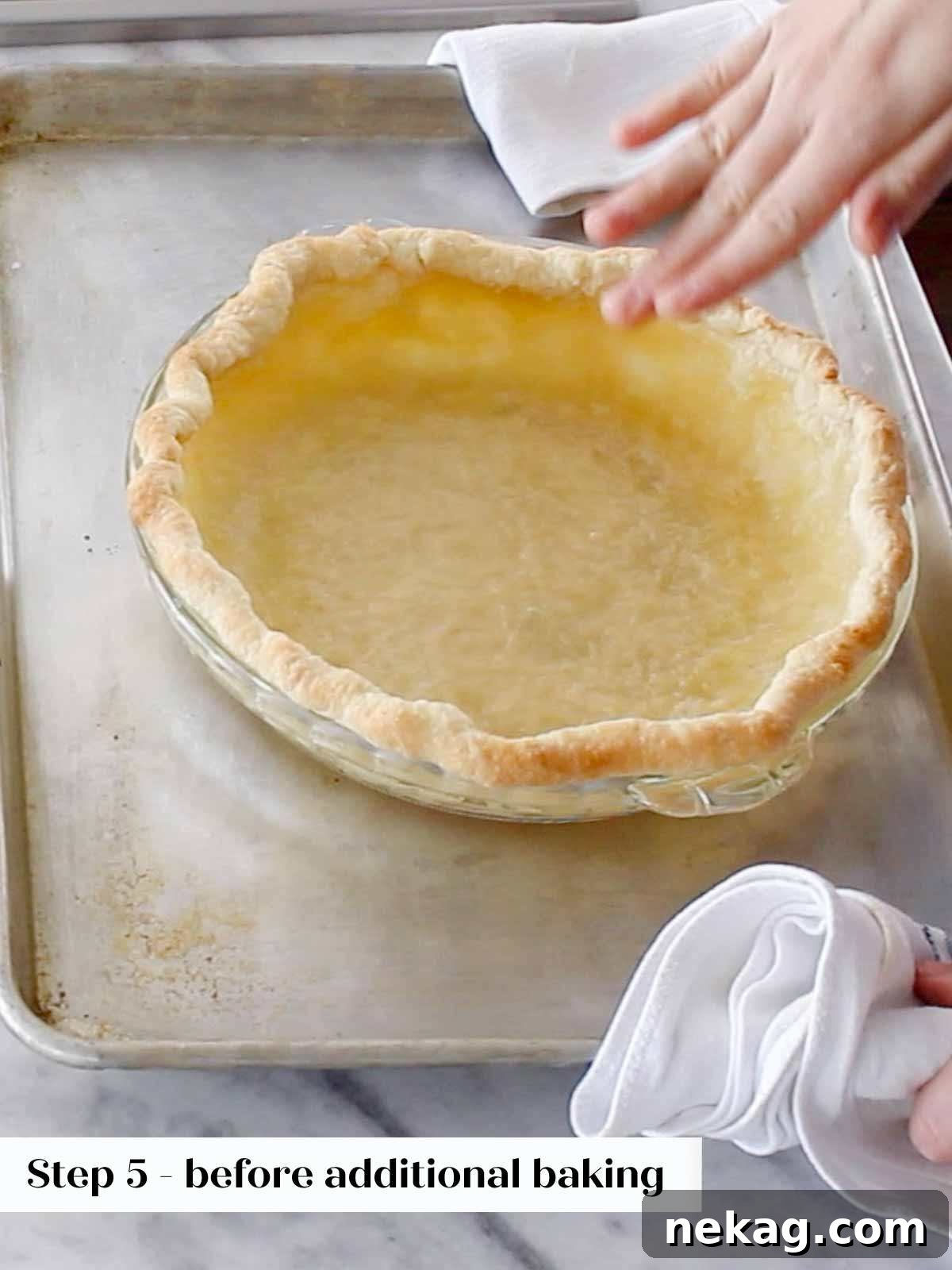 A blind-baked pie crust, golden and firm, after the removal of pie weights and parchment paper.