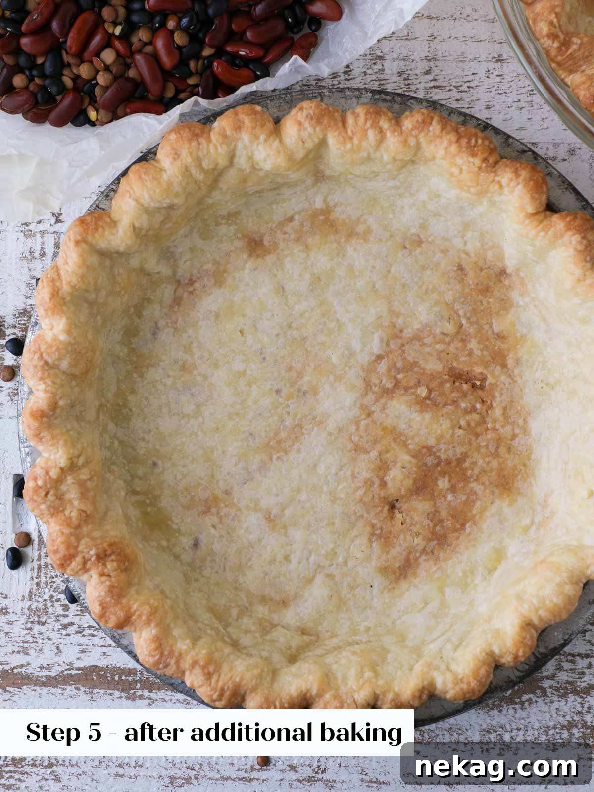 A perfectly partially baked pie crust, golden and ready for filling, showcasing a crisp and even base.