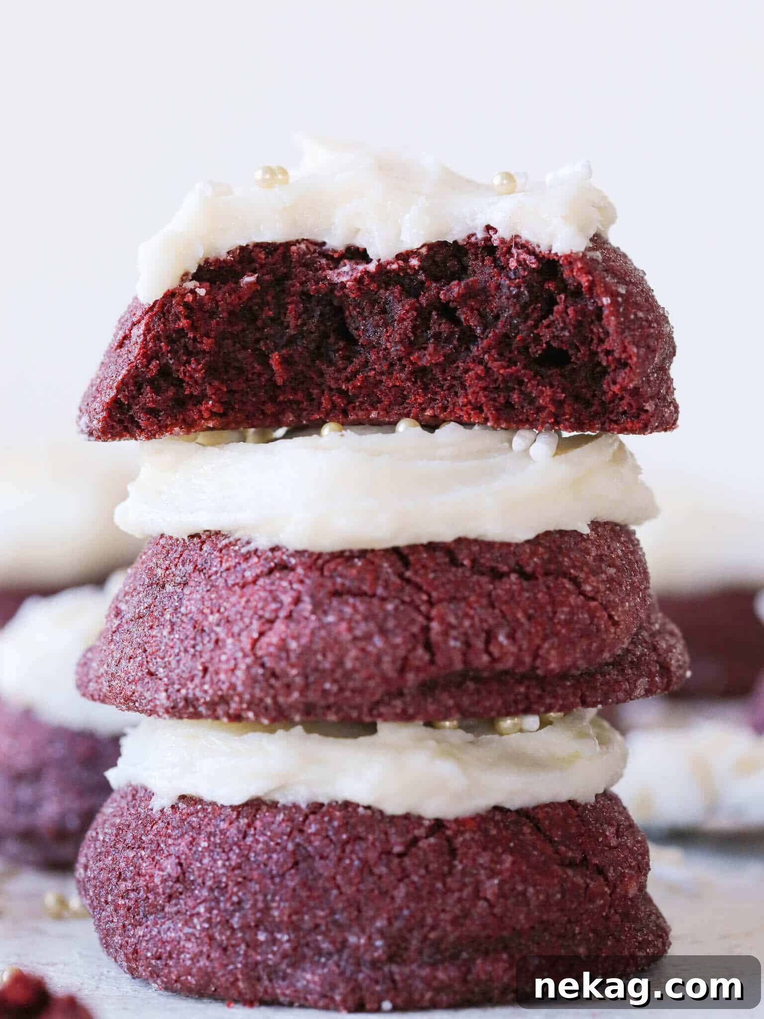 Stacked red velvet cookies, deep red in color, with a delicate sugar crust.