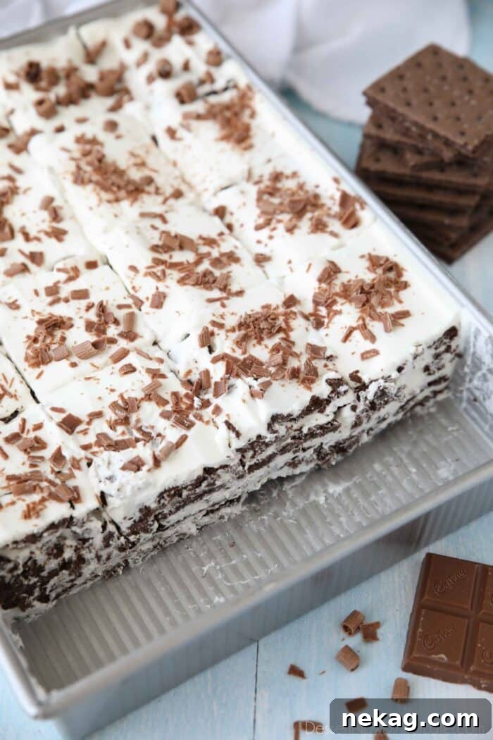 A pan filled with a traditional icebox cake, showcasing the beautiful layers of chocolate graham crackers and creamy whipped filling.