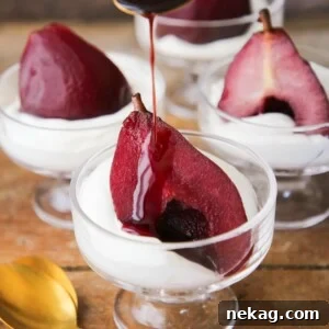 Delicious Easy Red Wine Poached Pear Dessert with sauce pouring over it.