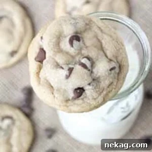 My favorite chocolate chip cookies placed next to a milk jug.