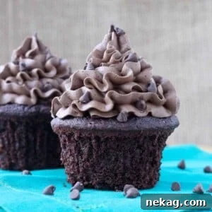 A rich chocolate cupcake generously topped with chocolate frosting.