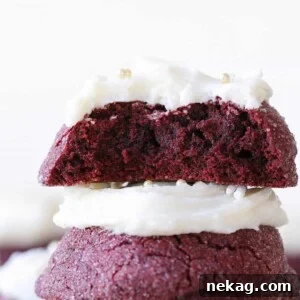 The soft and chewy inside of a red velvet cookie, stacked on top of another.